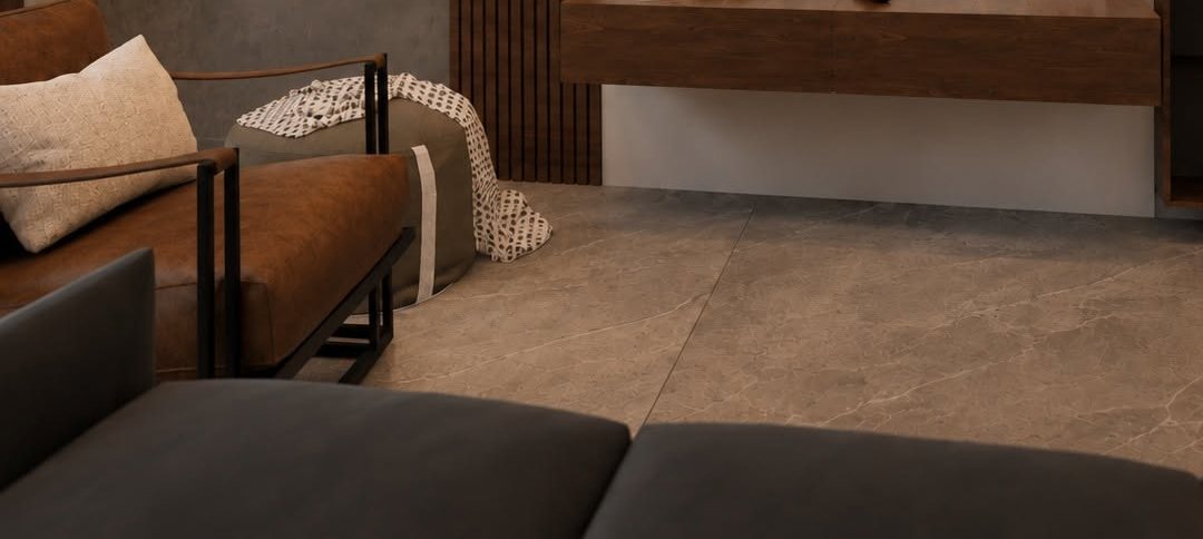 Cognac leather armchair and charcoal sofa facing a floating walnut media console